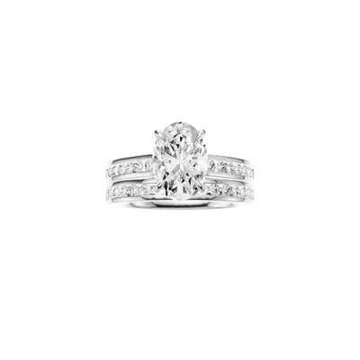 18ct EF VS laboratory grown diamond channel ring with a oval cut diamond in a hidden halo setting and a matching wedding band