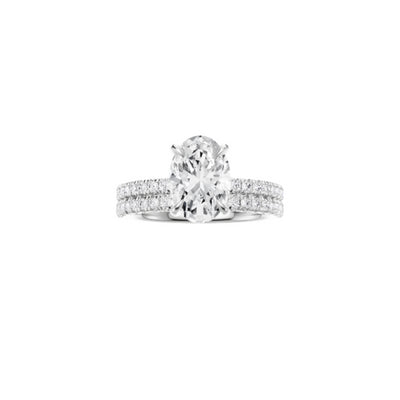 18ct EF VS laboratory grown diamond french pave ring with a oval cut diamond in a hidden halo setting and a matching wedding band